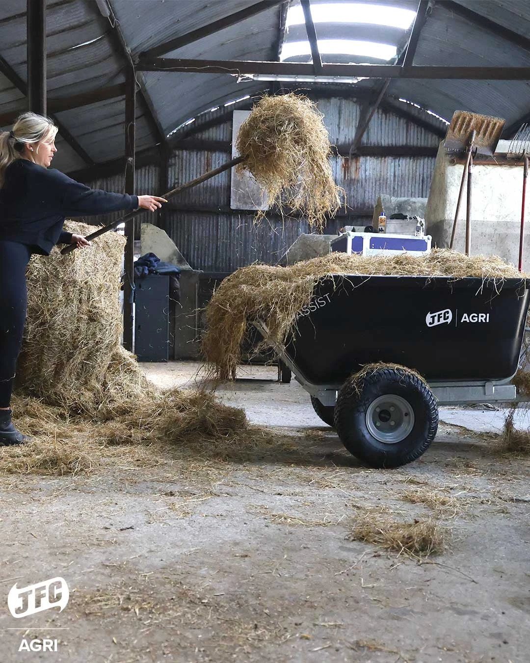 JFC Agri ATV Tip Assist Trailer, black, 500kg capacity, bed loaded with straw.