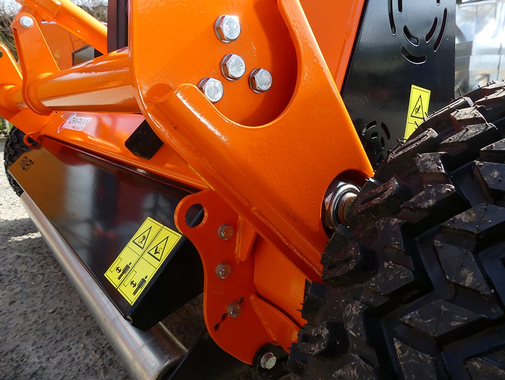 Chapman FM Pro ATV Flail Mower, orange steel frame with warning labels and visible wheel