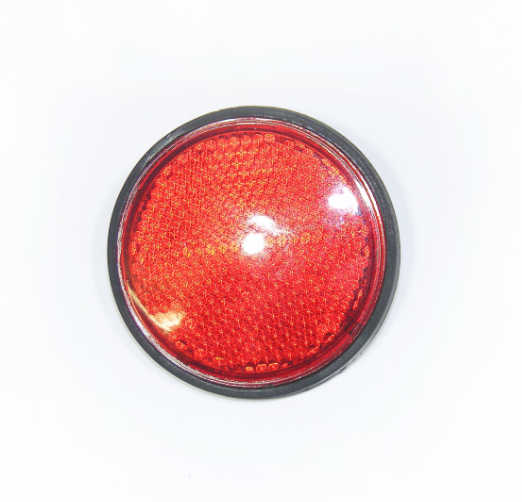Round red reflector with black rim for vehicle safety equipment