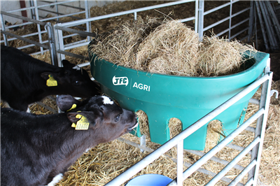 JFC Agri Gate Hay Feeder 100L, green 7-partition livestock feeder with two cows nearby.