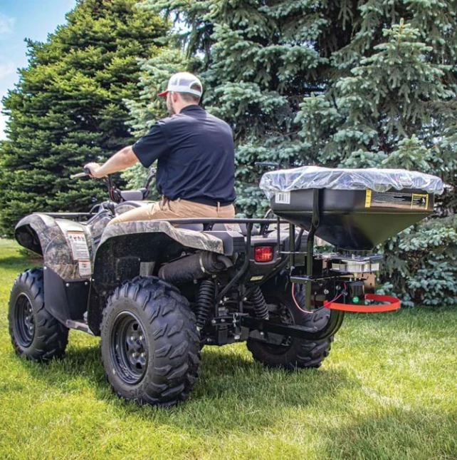 Fimco dry material spreader on ATV/UTV with 2-in receiver mount and rain cover