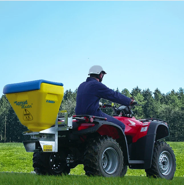 Spreader: C-Dax SpreadMaster SM70 FD mounted on a red ATV; yellow tank with blue lid