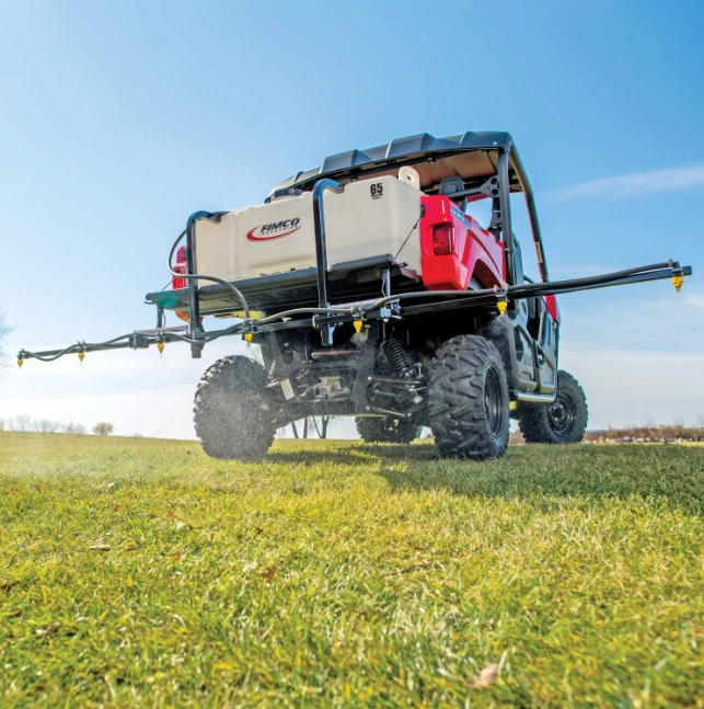 Fimco UTV Sprayer mounted on a red UTV with beige tank and long spray boom