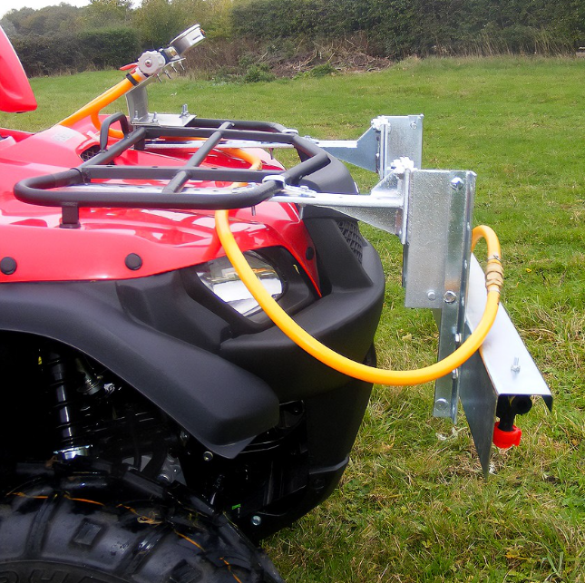 C-Dax front-mounted shrouded amenity sprayer boom on ATV; metal frame with orange hose.