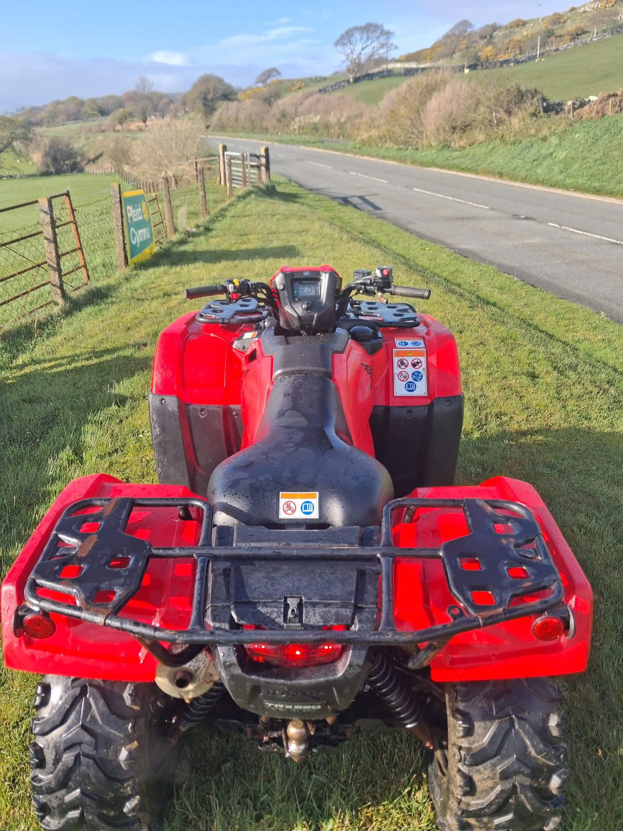 Used Honda TRX 520 FM6 manual ATV, red, front rider’s-view perspective