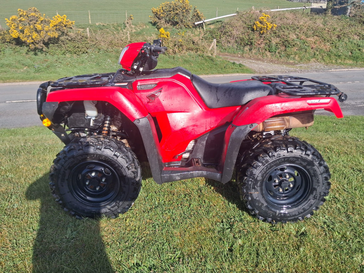 Honda red ATV TRX 520 with front and rear racks and rugged tires