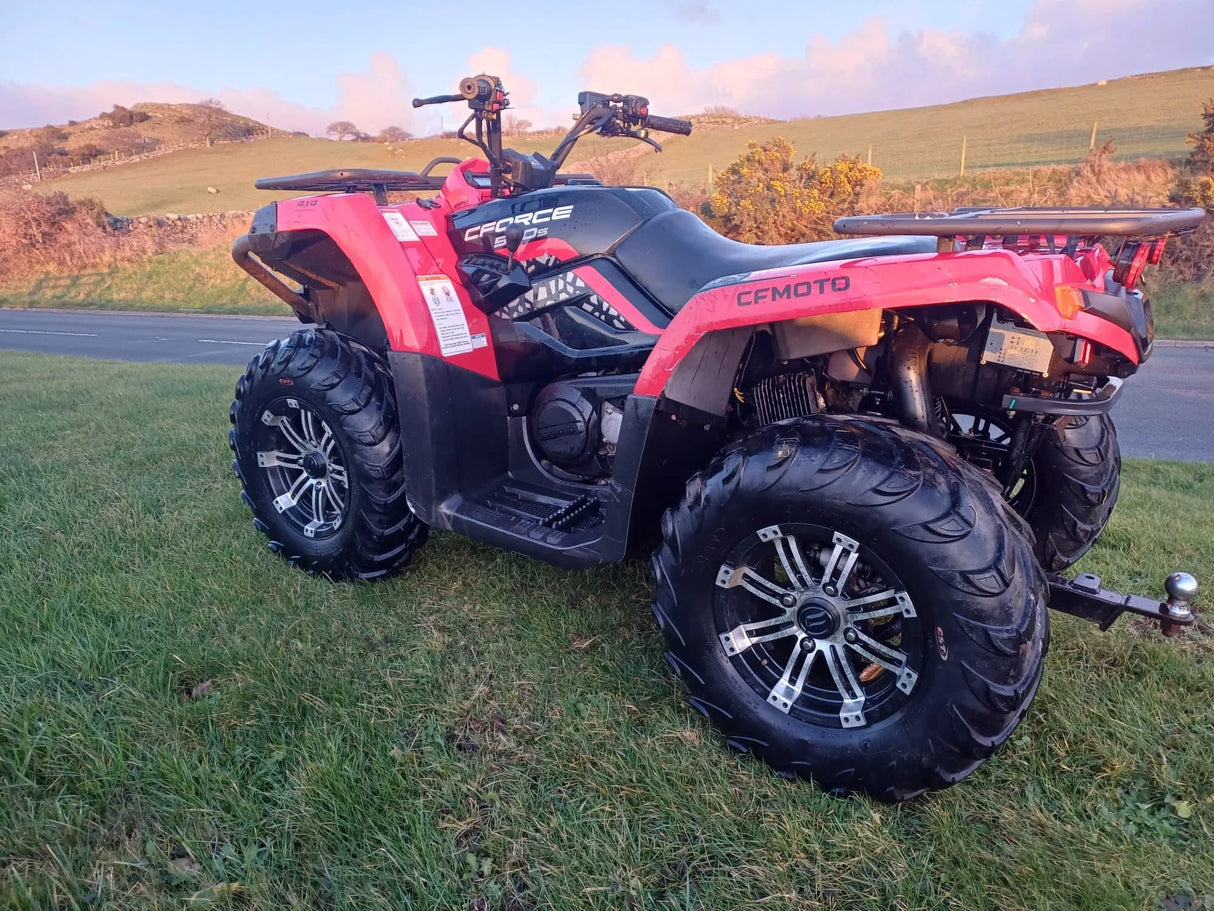 Used CFMOTO CFORCE 520 ATV, red/black, 2021 model with oversized knobby tires and rear cargo rack visible