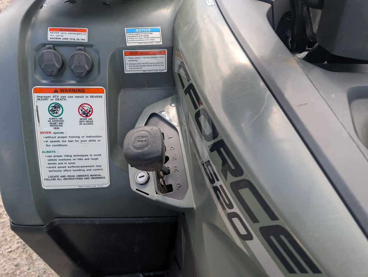 Used CFMOTO CFORCE 520 ATV with dual 12V ports and prominent warning decals.