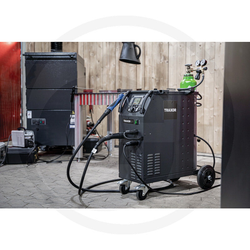TRAXOR Multi 320+ welding machine, black portable welder on wheels with cables and gauges in a workshop