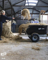 JFC Agri ATV Tip Assist Trailer, black, 500kg capacity, bed loaded with straw.
