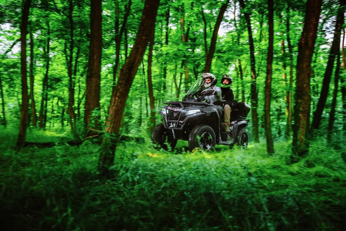CFMOTO CForce 625 Touring Overland ATV in Granite Ridge with ABS, two riders on a forest trail