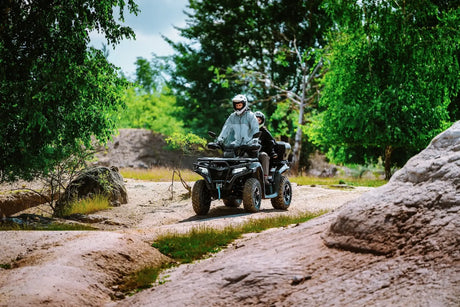 CFMOTO CForce 625 Touring Overland ATV in Granite Ridge with ABS, two riders on rugged trail