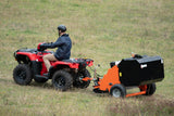 Chapman PC120 paddock cleaner in orange and black, attached to a red Honda ATV in a grassy field.