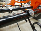 Chapman TH200 Tine Harrow frame on black tubular chassis; silver bolt and nut, workshop with orange equipment behind