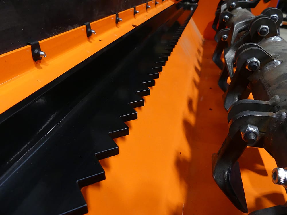Chapman FM Pro ATV Flail Mower orange housing with black serrated blades, close-up of blade drum and mounting hardware