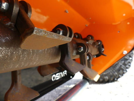 Chapman FM Pro ATV Flail Mower attachment, orange housing with rusted steel blade assembly and drive linkage