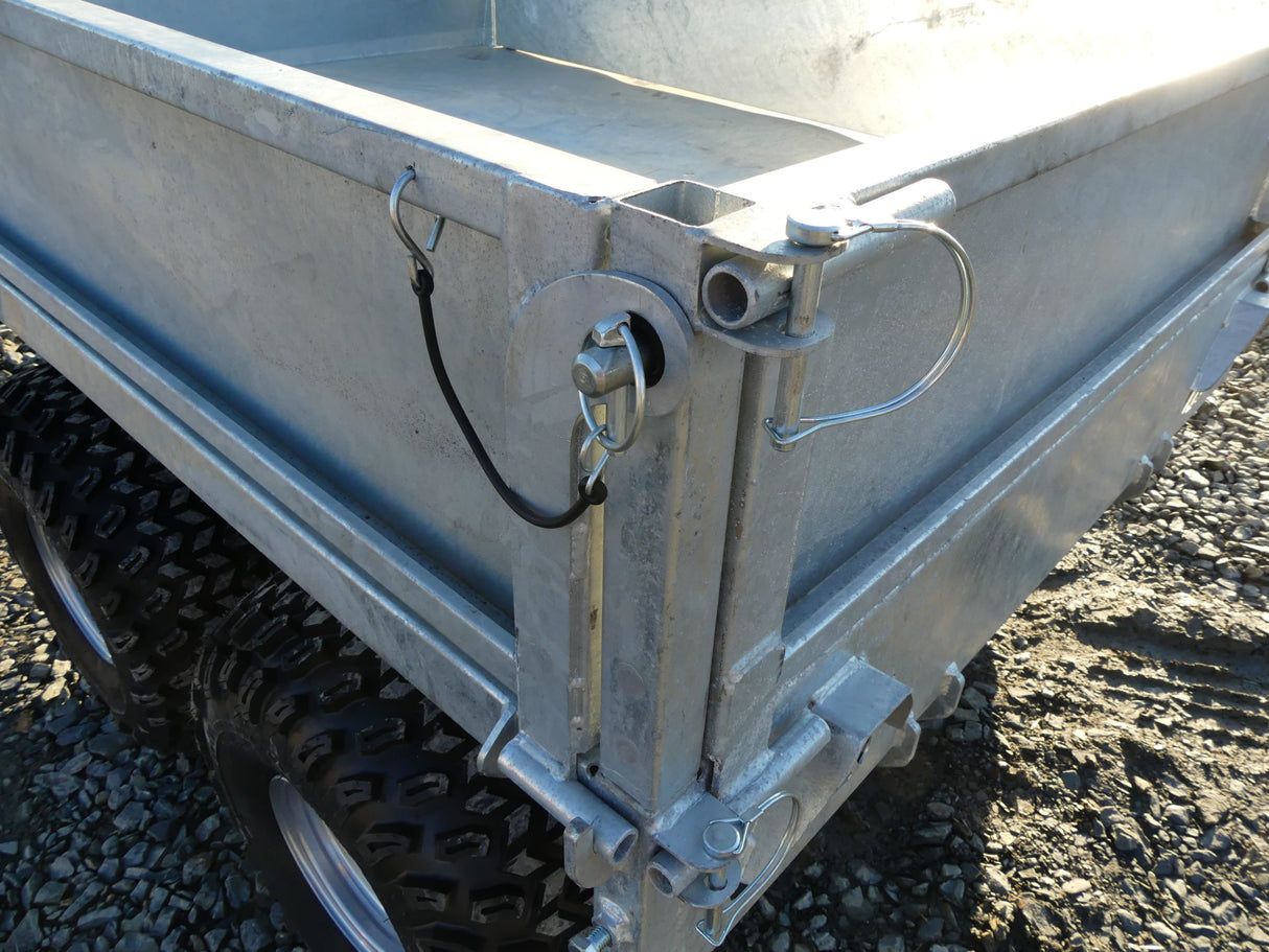 Chapman FT100 1-Ton flatbed tipping ATV/UTV trailer with electric tip, metallic silver finish.