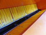 Chapman PC120 paddock cleaner interior with yellow brush rollers inside an orange hopper