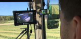 JFC Agri FarmCam HD Wireless Camera System with MachineCam display mounted in tractor cab showing field view.