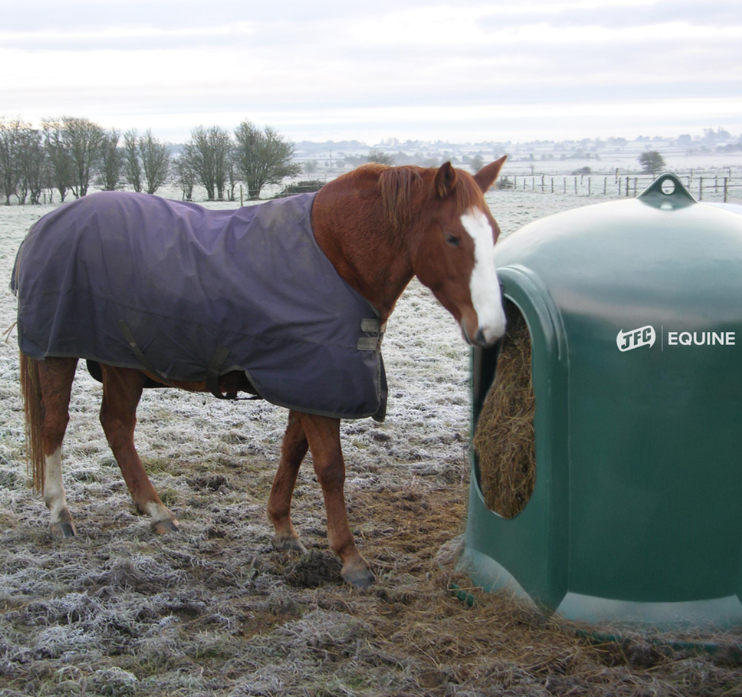 JFC Haybell Round Bale Cover Feeder, green JFC Equine bale feeder beside a horse