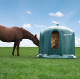 JFC Haybell Round Bale Cover Feeder, green plastic unit with JFC Equine branding on grass.