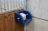 Blue JFC Agri mineral lick holder mounted on a stall wall for horse feed