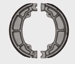 Brake shoe set MBS2307, two gray metal brake shoes with black friction lining along the outer edge.