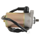 Starter motor with gold metallic housing and black wiring, gear shaft visible