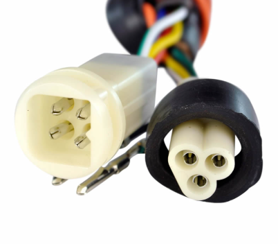 Performance CDI module for Yamaha ATV with white 4-pin and black 3-pin plugs and multicolored wires.