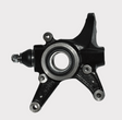 Steering knuckle for Honda TRX420; black metal with center bearing bore and mounting holes.