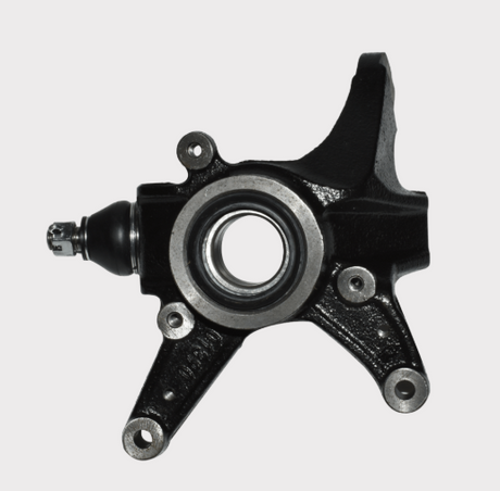 Steering knuckle for Honda TRX420; black metal with center bearing bore and mounting holes.