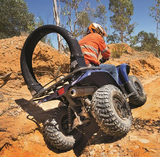 Replacement Cover Trax LifeGuard black on blue ATV in rocky off-road terrain.