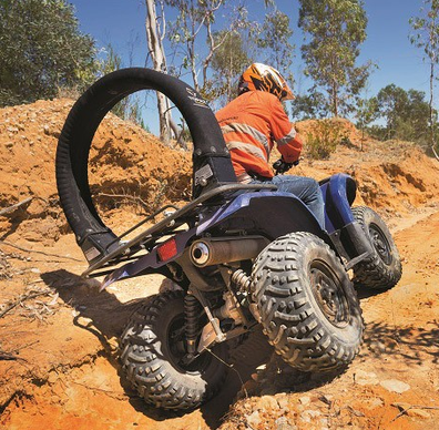 Replacement Cover Trax LifeGuard black on blue ATV in rocky off-road terrain.