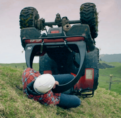 QuadGuard CPD & Mounting – Trax Black for ATV; red quad upside down with technician beneath helmet.