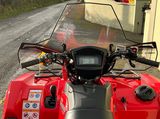 Windscreen for Cobra Pro-Tek Universal ATV (no headlight cut-out) mounted on a red ATV.