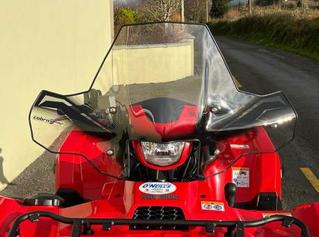 Windscreen Cobra Pro-Tek universal ATV windscreen on red ATV, clear windshield, no headlight cut-out