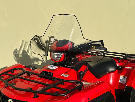 Windscreen Cobra Pro-Tek Universal ATV; clear windscreen on a red ATV with no headlight cut-out.