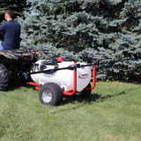 Trailer sprayer with 246L white tank on a red frame, 7-nozzle boom, 12V pump, FIMCO-branded, towed behind an ATV.