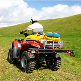 C-Dax MultiBoom ATV spray boom mounted on a red quad with a yellow spray tank in a grassy field.