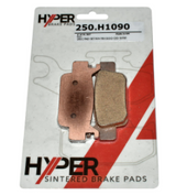 Front-right sintered brake pad set by Hyper, two copper-colored pads for ATV/UTV