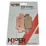 Front left-hand disc brake pad set, two copper-colored Hyper sintered pads in blister pack.