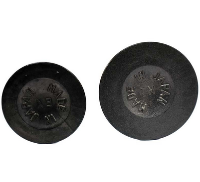 Engine valve pair, two black round valve heads with Made in Japan marking.