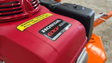 Chapman TS600 Pro ATV Trailed Strimmer with Honda 13hp engine; red engine cover and yellow warning label.