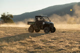 CFMOTO UFORCE U10 Pro Agri UTV in dark green/black 4x4 with roll cage on a dusty field.