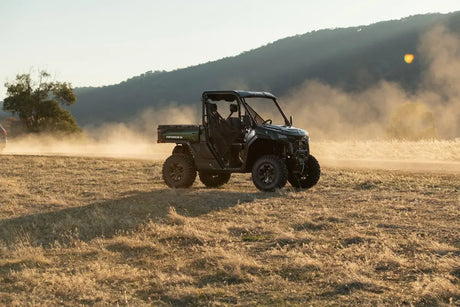 CFMOTO UFORCE U10 Pro Agri UTV in dark green/black 4x4 with roll cage on a dusty field.