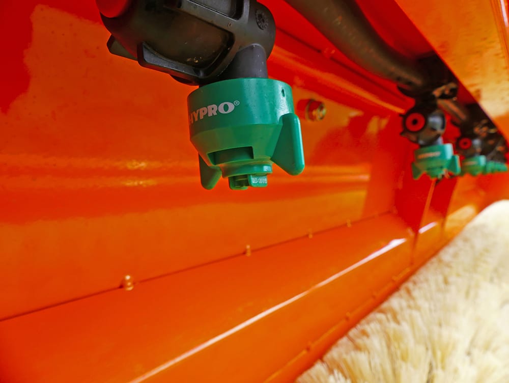 Chapman T240 Tractor Mounted Weed Wiper brush roller with green HYPRO nozzles on an orange frame