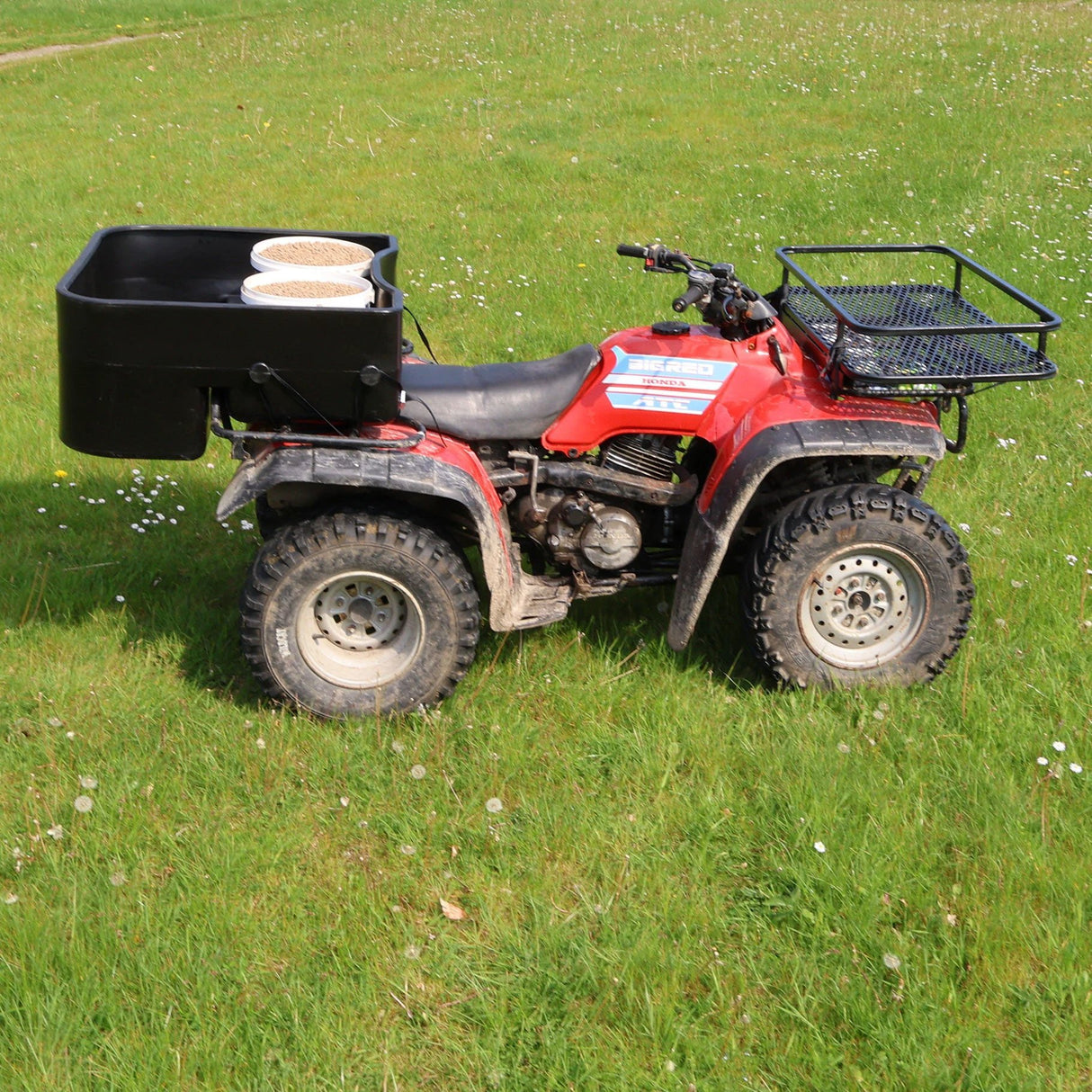 ATV Shallow Carrier Box in black with 200L capacity, lightweight and universal fit, mounted on a red ATV