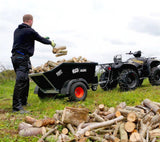 JFC Agri ATV hydraulic tipping trailer, 500 kg capacity, black; hitched to an ATV as a man loads firewood.