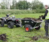 JFC Agri 500kg hydraulic tipping trailer, black, attached to an ATV, loaded with rocks.