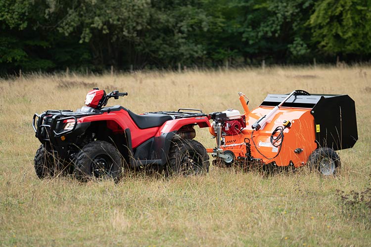 Chapman PC120 paddock cleaner orange unit attached to red ATV in a field